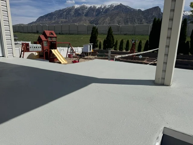 Light gray deck coating on residential elevated deck with concrete support columns