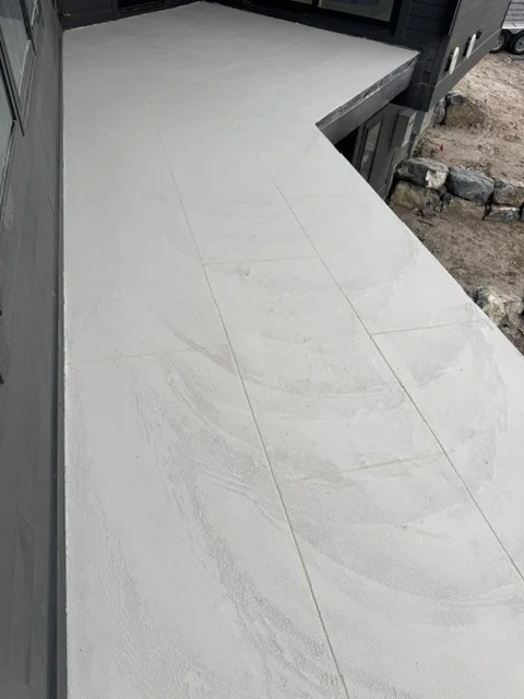 Gray concrete deck coating with control joints on large outdoor surface