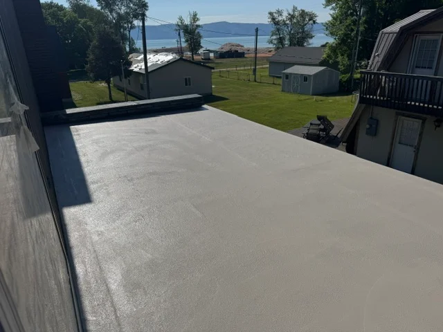 Light gray deck coating applied to large residential deck with waterfront view