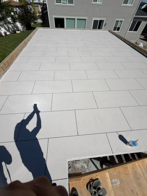 Light gray porcelain pavers in running bond pattern on residential patio with clean grout lines