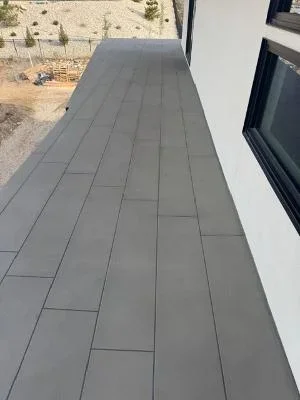 Gray composite deck coating in running bond pattern, newly installed