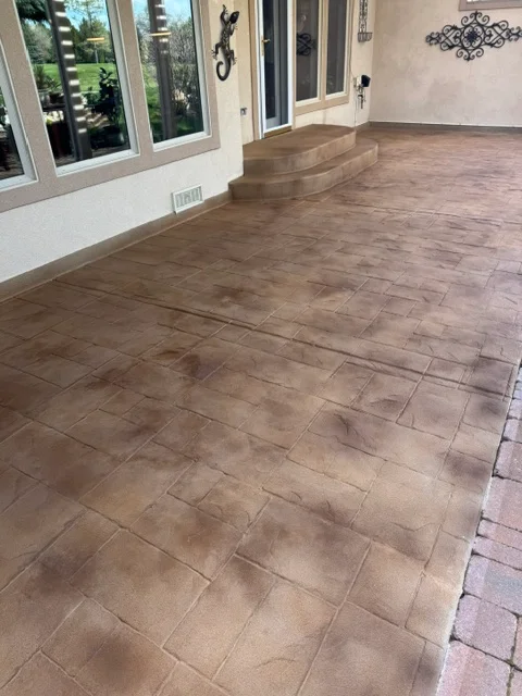 Interior concrete floor with professional coating, step feature, and large windows