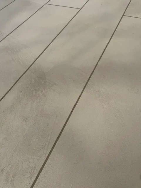 Light gray deck coating on diagonal plank deck surface with uniform finish