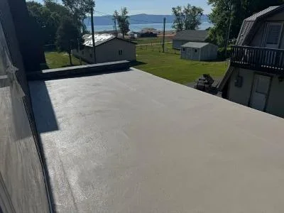 Gray protective deck coating applied to large residential deck surface