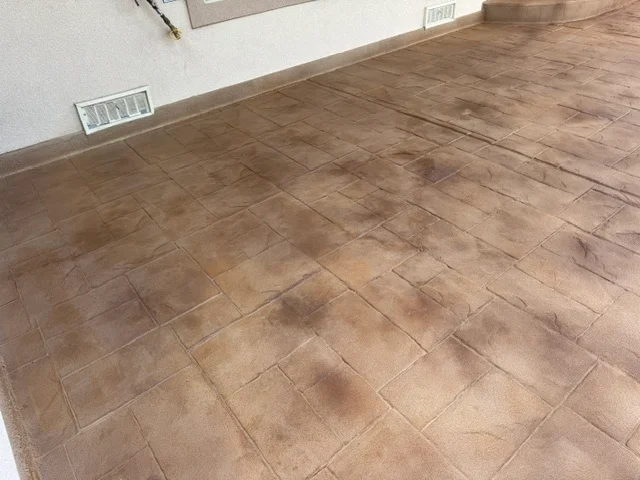 Wood-look decorative concrete floor coating with brown tones and grain pattern