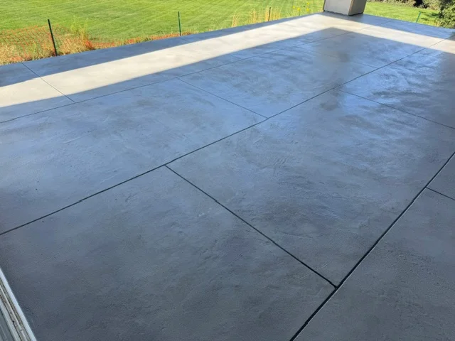 Stamped concrete deck with slate-pattern coating and contrasting border stripe