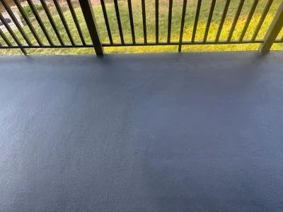 Newly coated deck surface with slatted overhead structure and protective finish