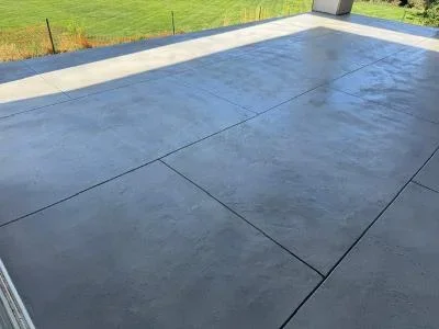 Dark gray deck coating on large concrete deck with clean seams and uniform finish